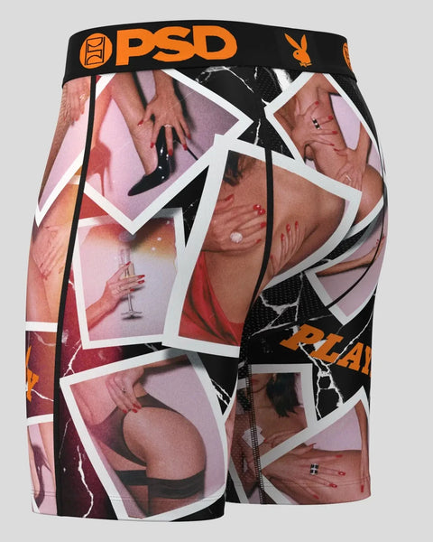 Black PSD boxer briefs with orange waistband featuring overlapping Polaroid-style photo prints and Playboy bunny logo.