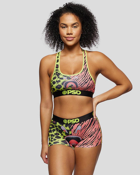 Sports bra and shorts set with neon yellow leopard print, pink striped pattern, and cat eye design with black PSD waistband.