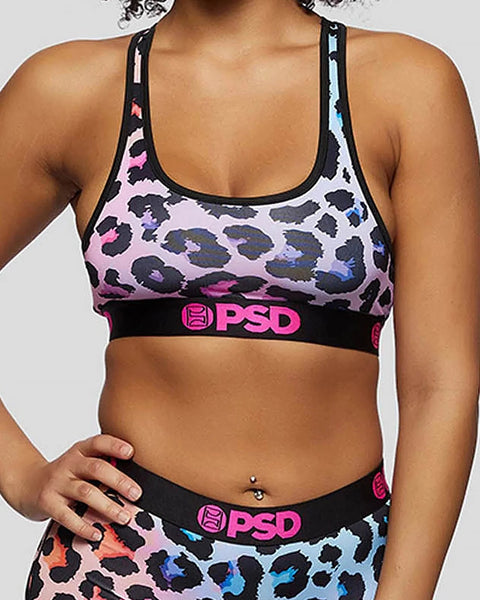 Sports bra with multicolor cheetah print pattern, black trim, and PSD branding on waistband.
