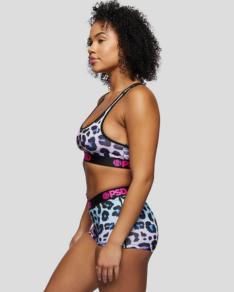 Multicolored leopard print sports bra and shorts set with black waistbands featuring pink branding.