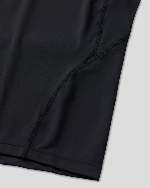 Black compression tee with short sleeves, showing fitted fabric and reinforced seaming detail.