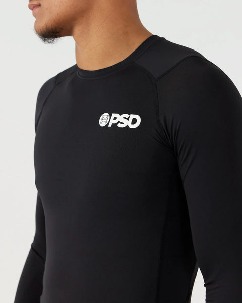 Black long-sleeve compression tee with white PSD logo on chest, fitted construction visible on torso and shoulders.