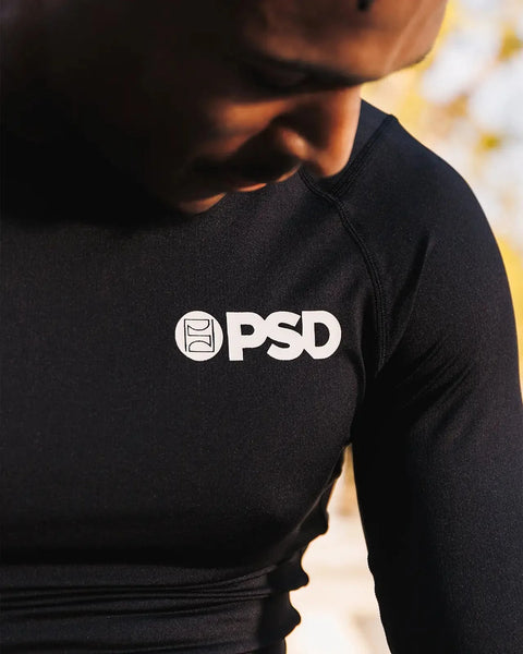 Black long-sleeve compression tee with white PSD logo on chest, fitted to torso.