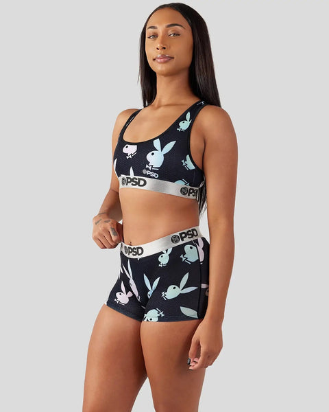 Woman wearing black sports bra and shorts with white rabbit print and gray PSD waistband.