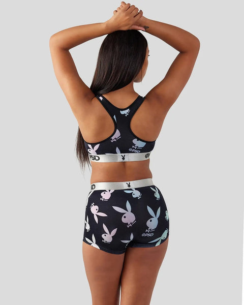 Black sports bra and shorts set with multicolored bunny print and gray waistbands, worn by model shown from back.