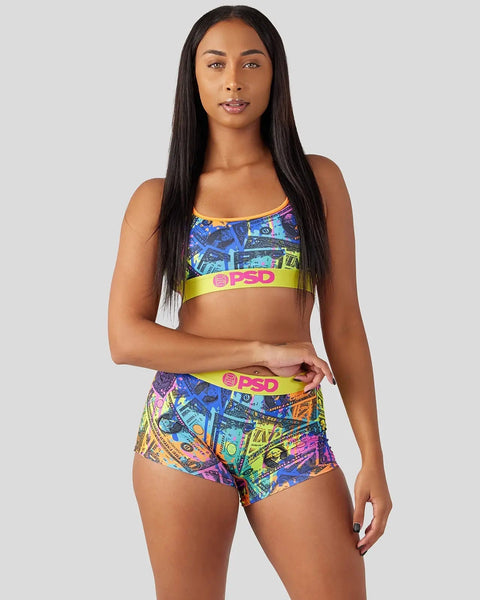 Colorful sports bra and shorts set with blue, yellow, and neon geometric print and lime yellow waistband.