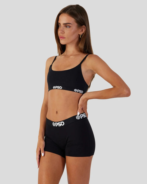 Black sports bra and shorts set with PSD branding on elastic bands.