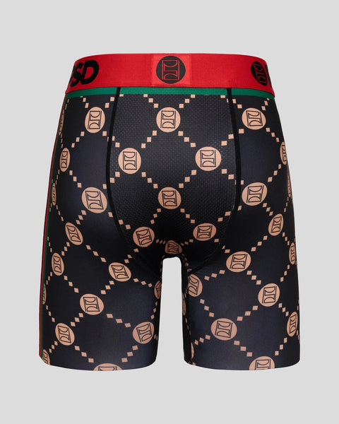 Black boxer shorts with peach-colored geometric emblem pattern and red waistband with green trim.