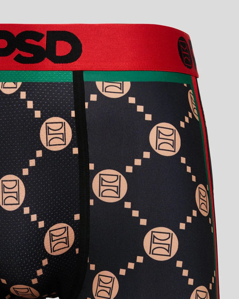 Black boxer briefs with tan geometric emblem pattern, red waistband with black text, and green trim detail.