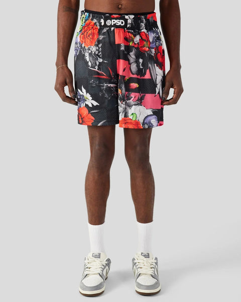 Men's athletic shorts with black base, red and orange floral print, PSD waistband label, and mesh fabric.