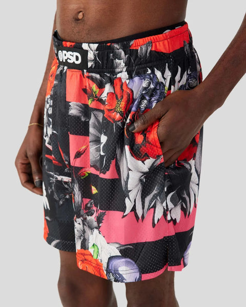 Men's athletic shorts with black, red, and pink floral patchwork print and mesh panels.