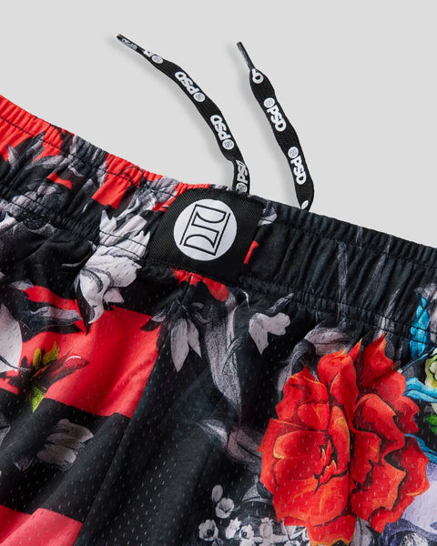 Black active short with red and pink floral print, adjustable drawstring straps, and circular logo patch on waistband.