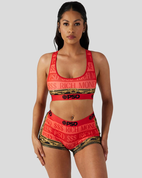 Woman wearing red sports bra and matching shorts with 