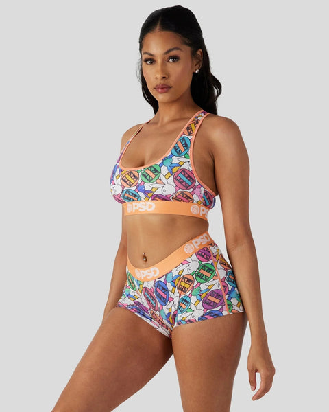 Playboy Geo two-piece set with colorful geometric print, orange waistbands, and racerback sports bra top.