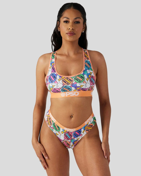 Colorful geometric patterned two-piece bikini with orange waistband and matching racerback top on model.