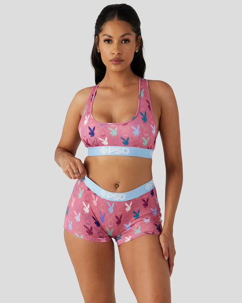 Pink racerback sports bra and shorts set with multicolored bunny print and light blue elastic bands.