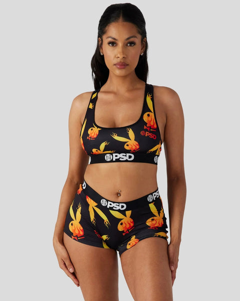 Black sports bra and boy shorts set with yellow and orange flame print and PSD branding.