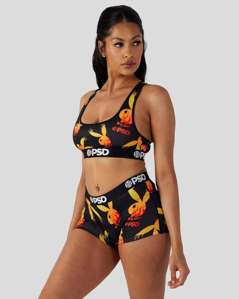 Black sports bra and shorts set with yellow and orange flame print and PSD branding.