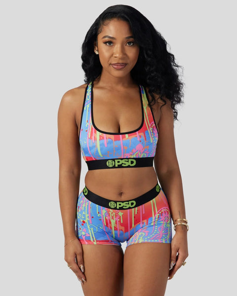 Colorful paisley-patterned sports bra and shorts set with black PSD branding and trim.
