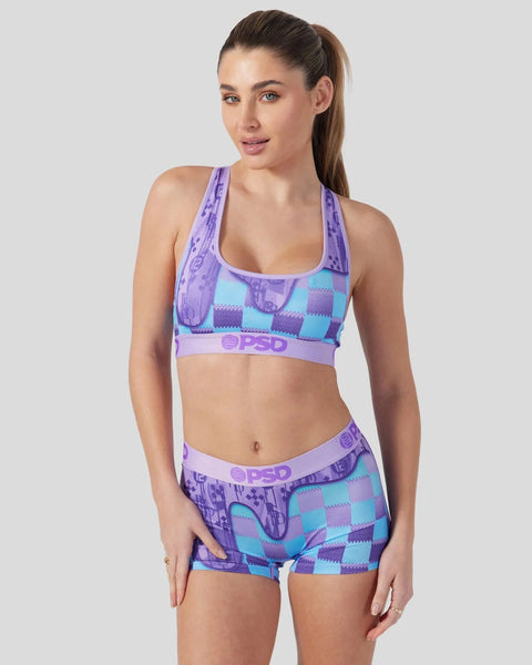 Women's sports bra and shorts set in purple and turquoise argyle pattern with PSD branding.