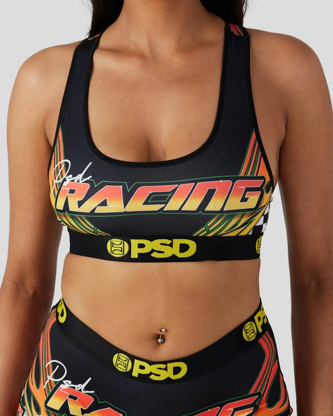 Black sports bra with "Road Racing" text in red, yellow, and orange gradient, PSD branding, and striped side panels.