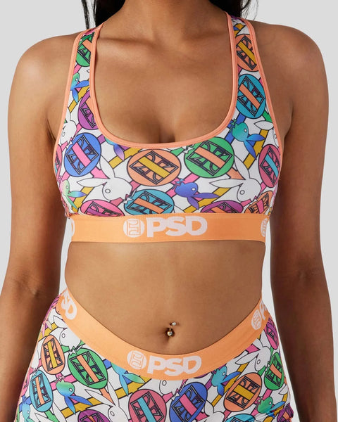 Playboy Geo sports bra with colorful geometric boat print, coral trim, and PSD waistband.