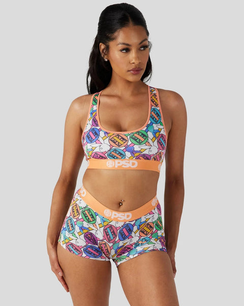Colorful geometric patterned sports bra and shorts set with orange PSD branding on waistbands.