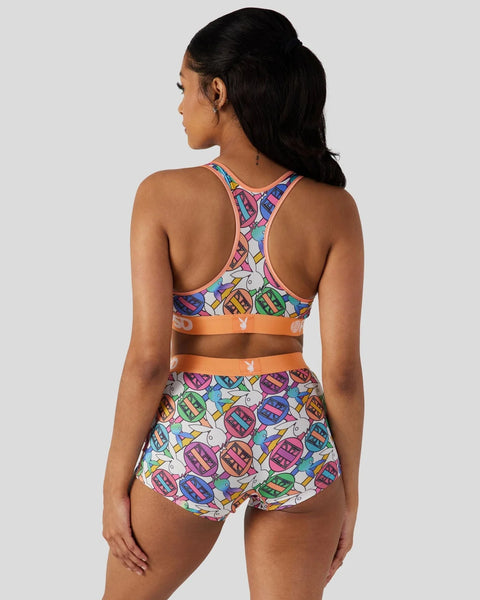 Playboy Geo two-piece swimsuit with colorful geometric print, racer-back crop top, and high-waisted brief bottom with orange 