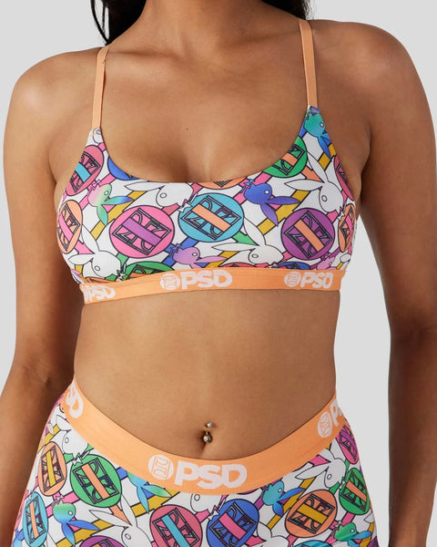 Colorful geometric patterned bra with thin straps and orange elastic waistband featuring brand logo.