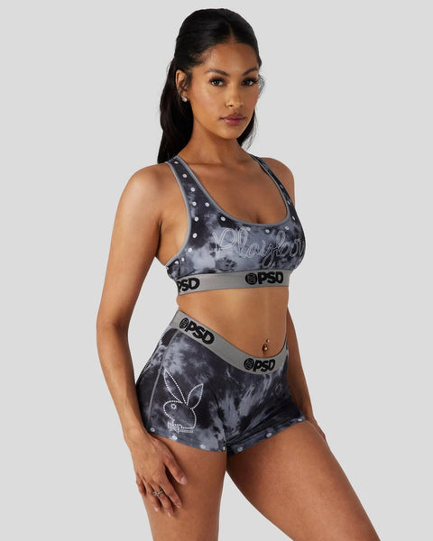 Black tie-dye sports bra and shorts set with Playboy branding, studded details, and gray elastic bands.
