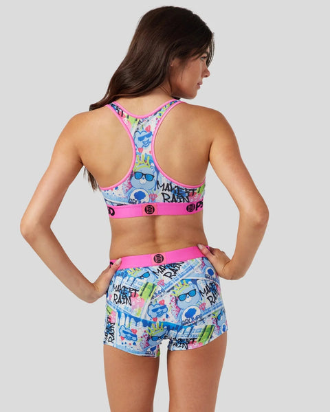 Care Bears-printed sports bra and shorts set with neon pink trim and colorful character graphics.