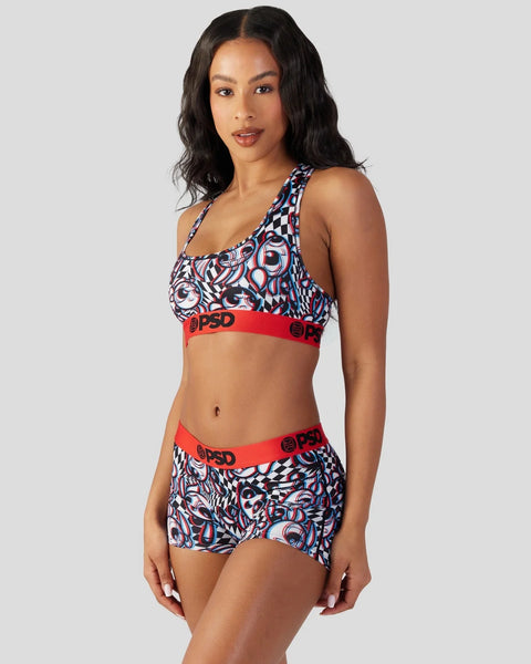 Woman wearing a two-piece set with red elastic waistbands and blue, white, and red patterned fabric throughout.