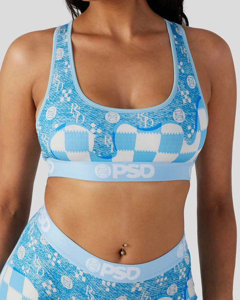 Blue and white patterned sports bra with checkered and logo design, racerback straps and branded waistband.