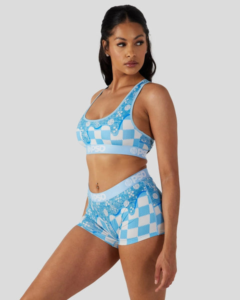 Woman wearing a blue and white checkered sports bra and matching shorts with printed text details.