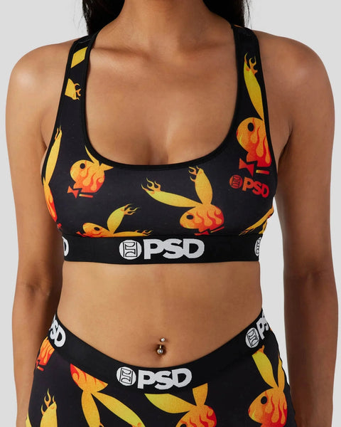 Black sports bra with yellow and orange flame-patterned birds and PSD branding on elastic band.
