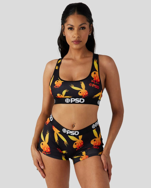 Black sports bra and shorts set with yellow and orange flame print and PSD branding.