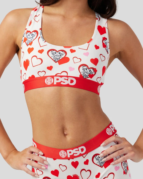 White sports bra with red and pink hearts and cartoon character print, red PSD waistband.