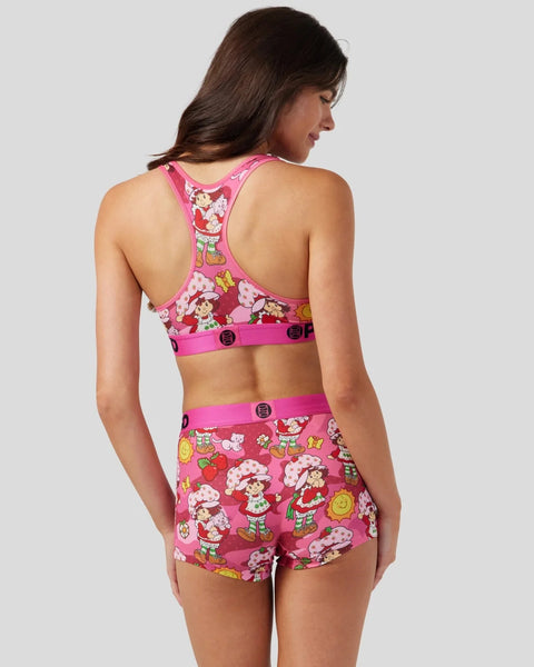 Pink and red two-piece set with strawberry shortcake character print, pink trim, and button details on waistband.