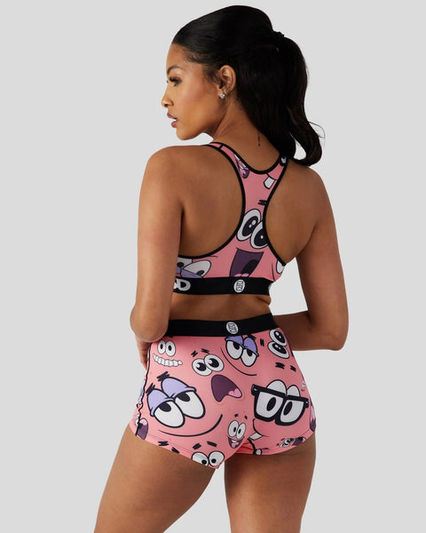 Pink sports bra and shorts set with cartoon character face prints and black trim details.
