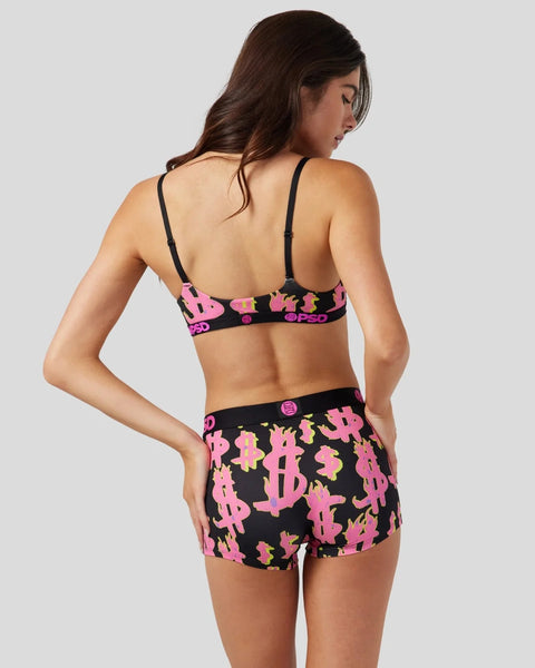Woman wearing black sports bra and matching shorts with pink and yellow dollar sign and flame print.