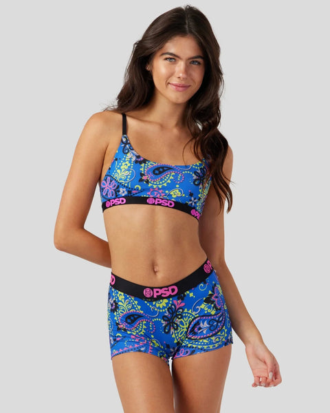Blue underwear set with neon paisley and floral print, black waistband with pink logo.
