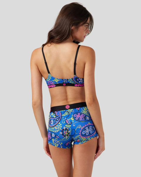 Woman wearing black choker-style bandana with blue paisley-patterned bikini top and matching shorts with black bands.
