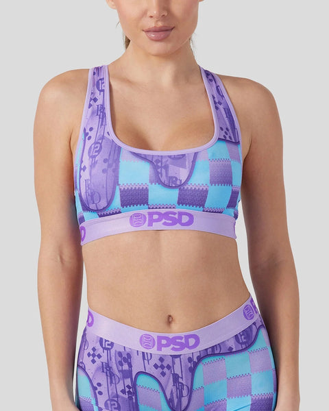 Women's sports bra with purple and turquoise checkered pattern, purple patterned straps, and PSD branding on elastic band.