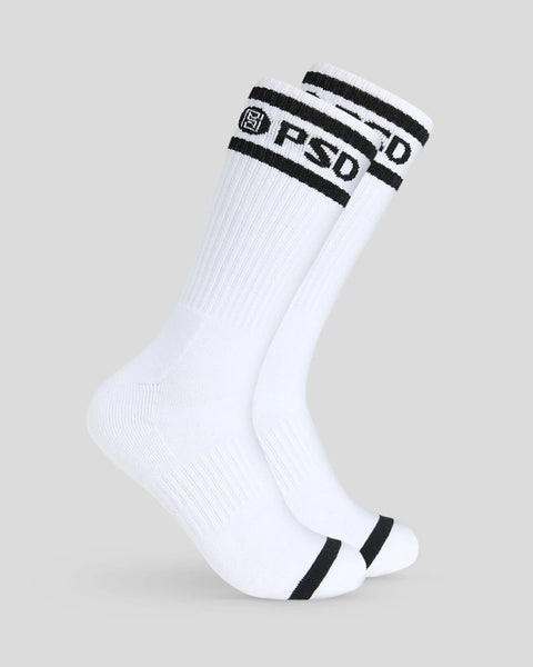 Three white crew socks with black stripes and PSD logo text on cuff.