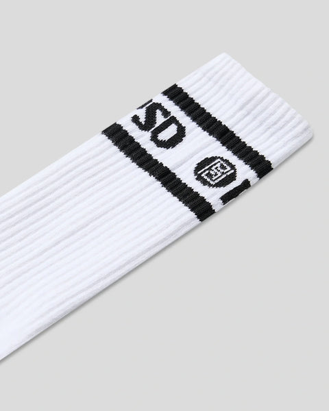 Three white crew socks with black logo stripes and text detail on the cuff.