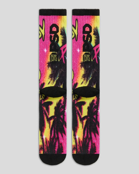 Pair of crew socks with neon pink, yellow, and black graphic design featuring silhouetted figures and Playboy branding.