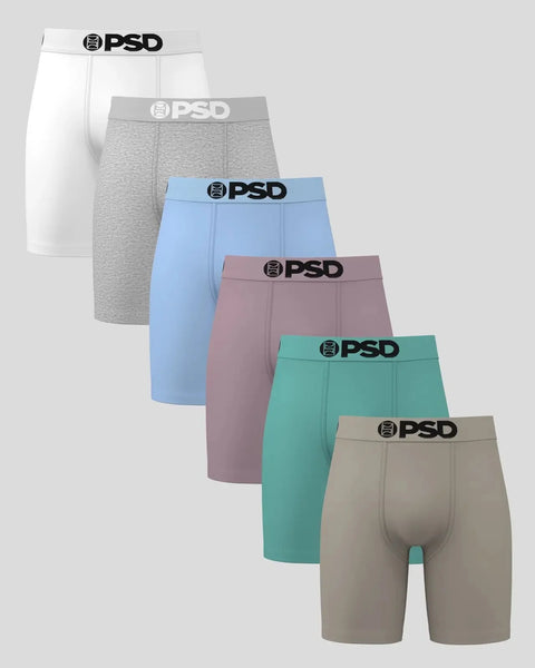 Six PSD boxer briefs in white, gray, blue, mauve, teal, and tan with black logo waistbands.