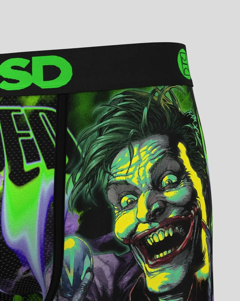 Black waistband with neon green branding and graphic illustration of grinning character face in yellow, green, and purple ton