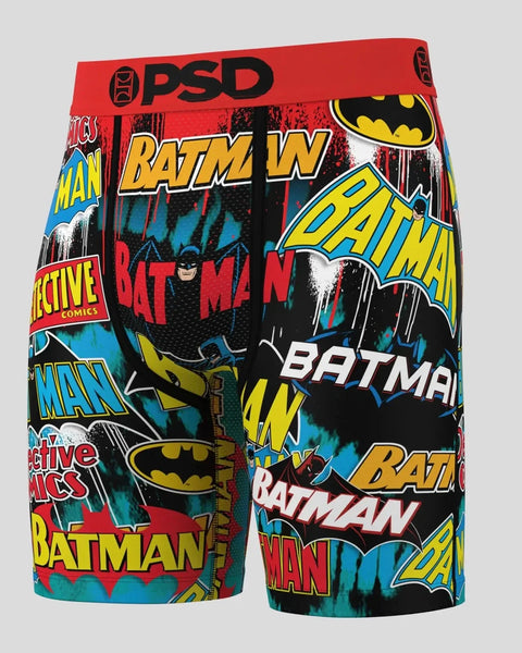 PSD boxer shorts with Batman logo and text pattern in red, yellow, and blue on black background.