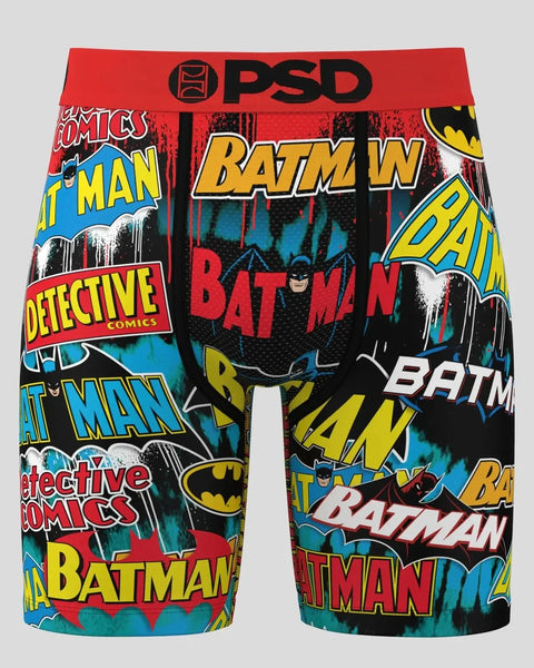 PSD brand boxer shorts with Batman comic book logos and text in yellow, red, and blue on black background.
